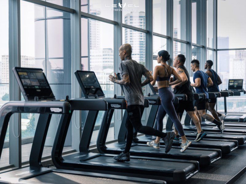 Người đàn ông đang chạy bộ trên máy chạy bộ tại phòng gym